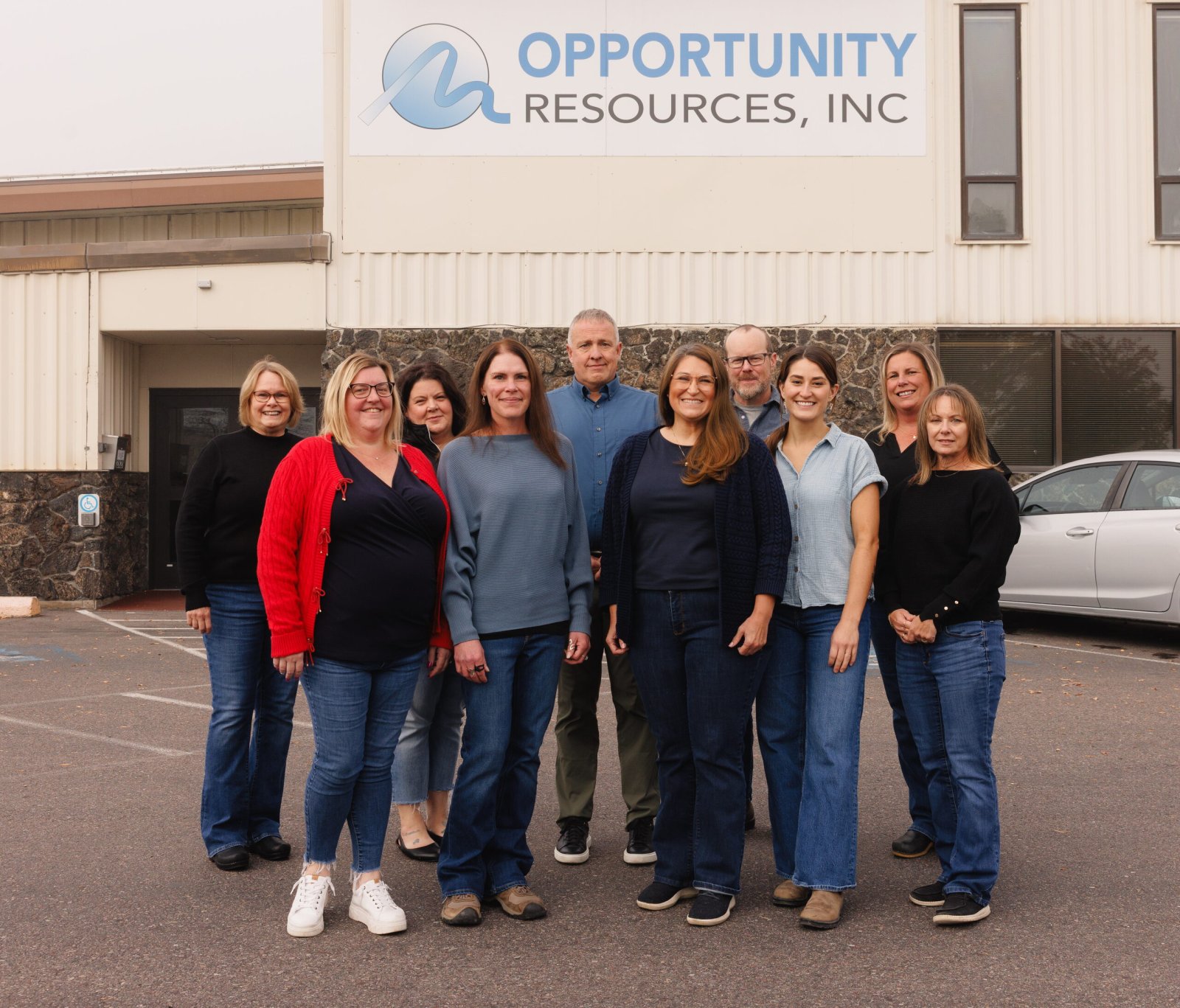 Members of the ORI staff stand together outside the Opportunity Resources building.